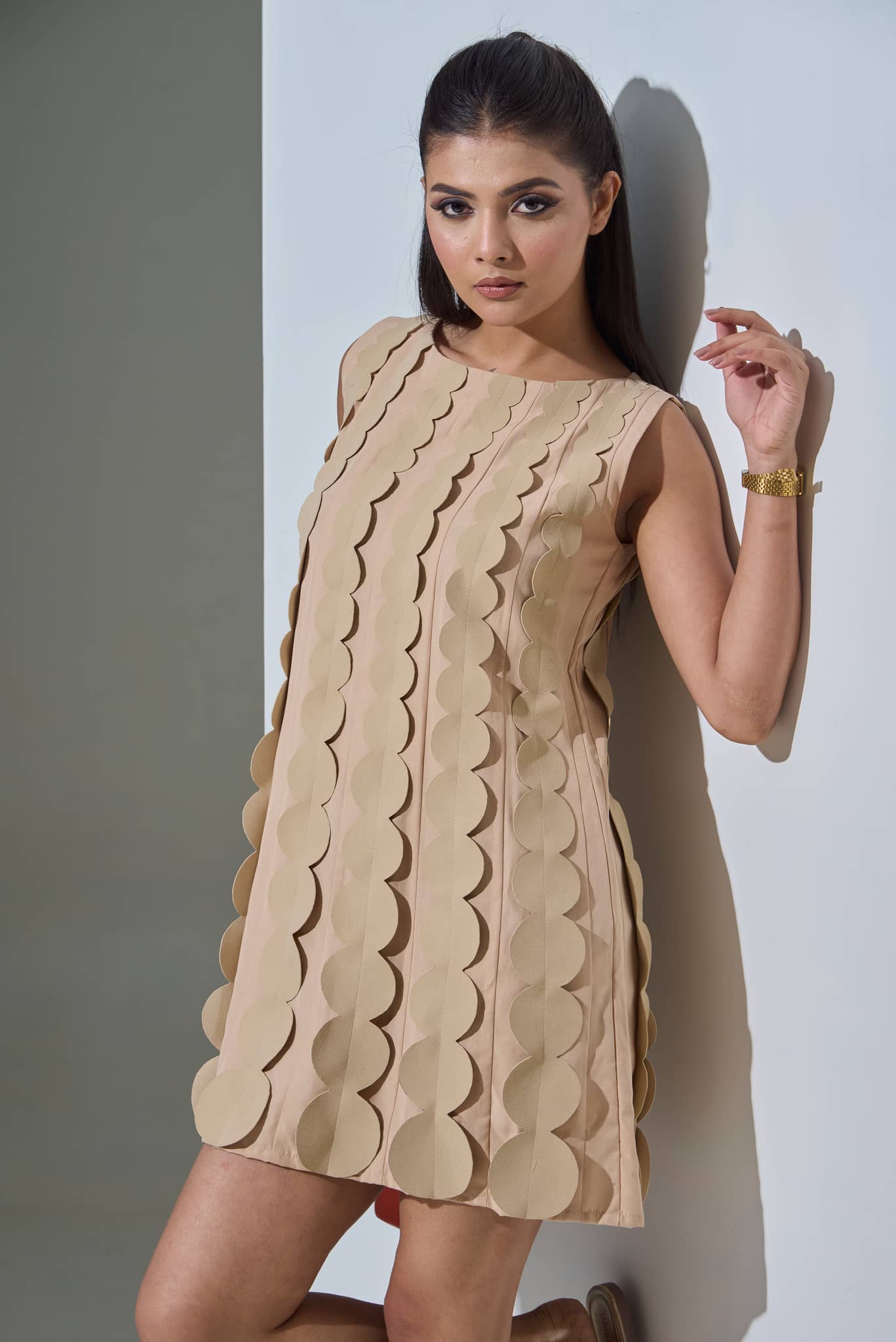 Elegant evening wear gown in beige with unique scallop detailing, perfect for formal events.