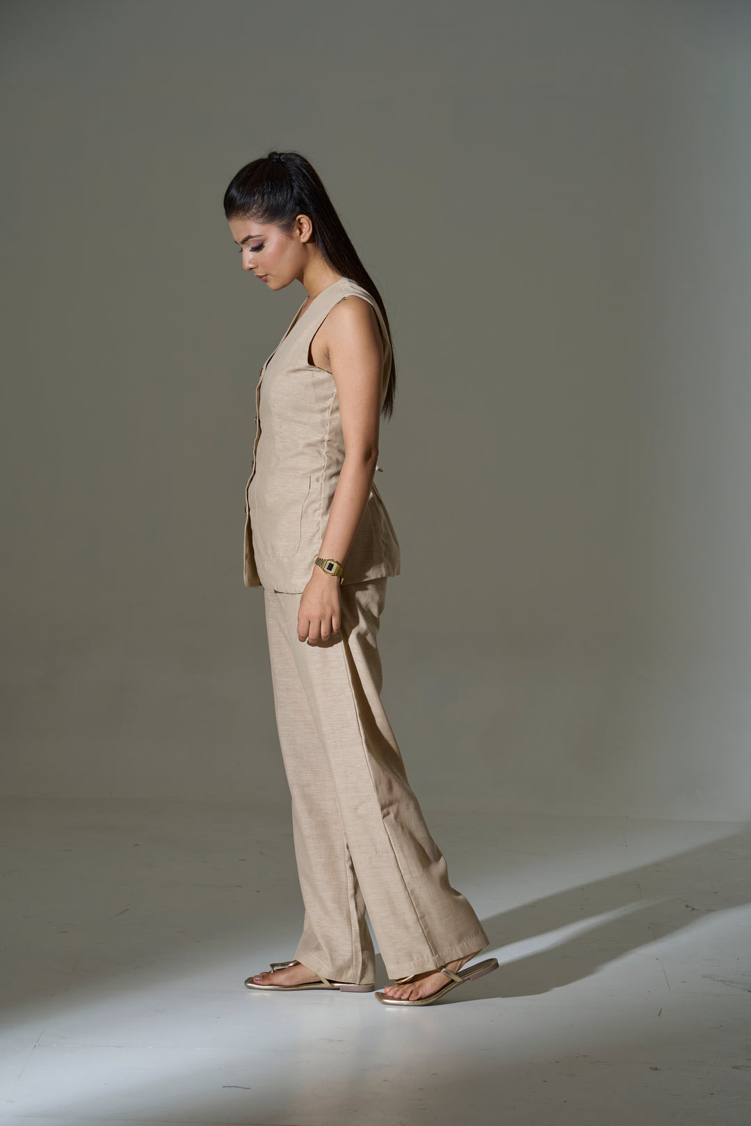 Model wearing a beige sleeveless V neck Waist coat and pants