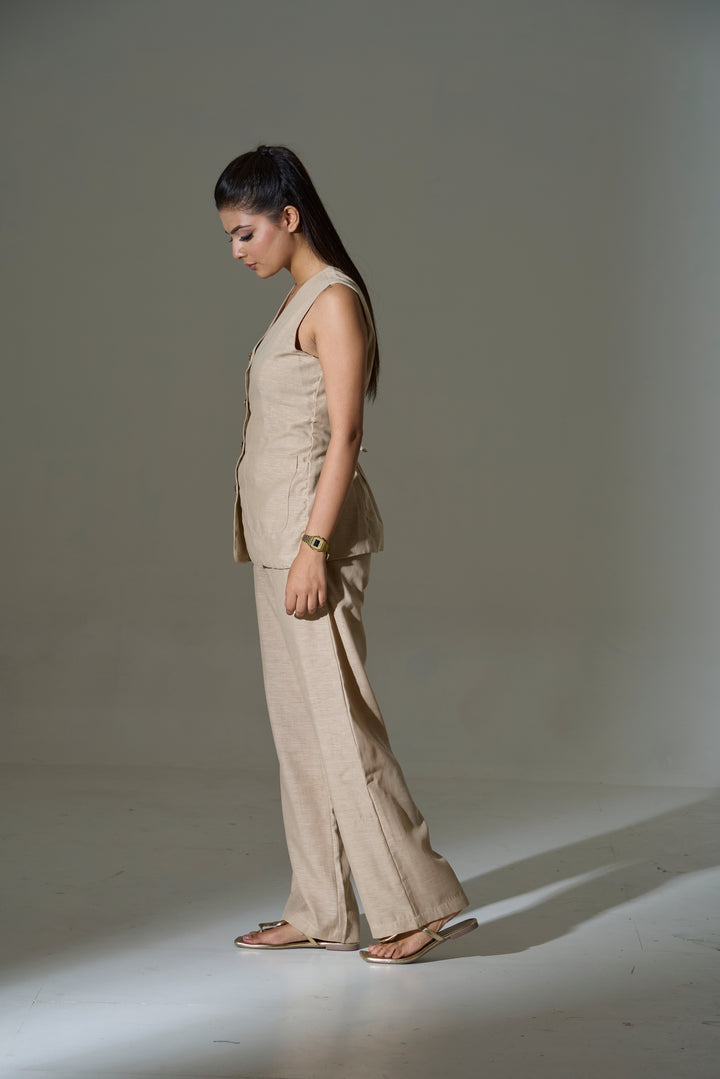 Model wearing a beige sleeveless V neck Waist coat and pants