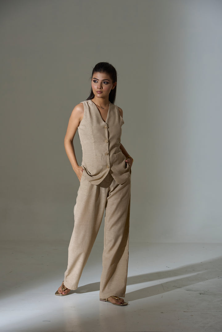 Model wearing a beige sleeveless V neck Waist coat and pants