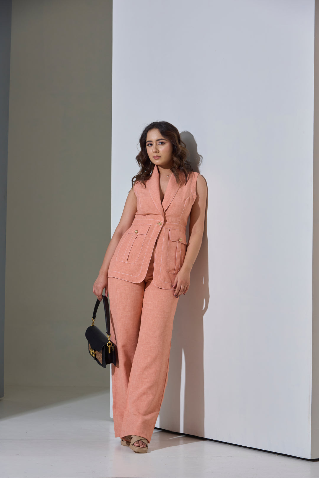 Model wearing Sleeveless Top stitch Waist Coat with Pants