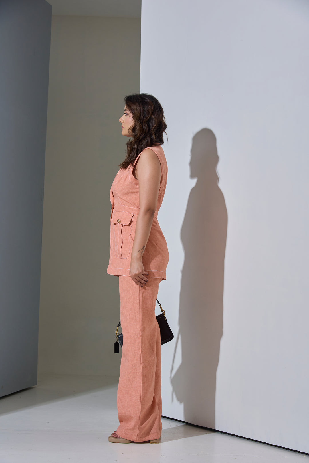 Model wearing Sleeveless Top stitch Waist Coat with Pants