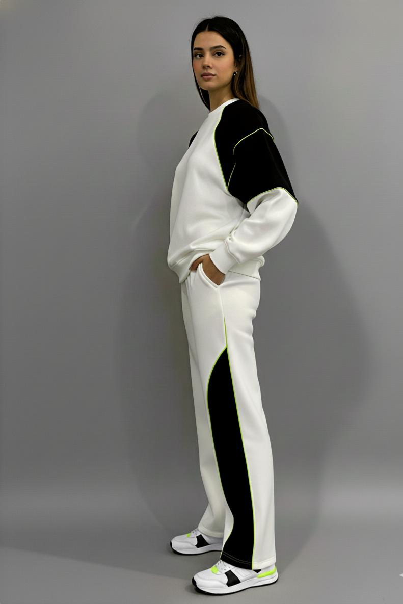 Person wearing a white and black tracksuit with a gray background