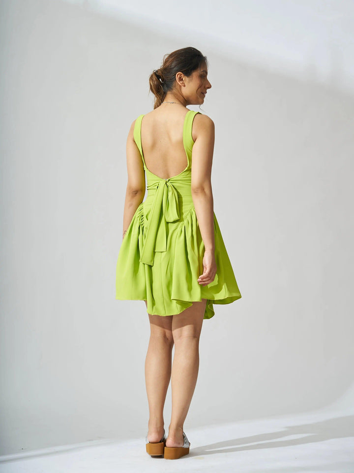 Risate backless bow mini dress in vibrant green with a stylish tied back design