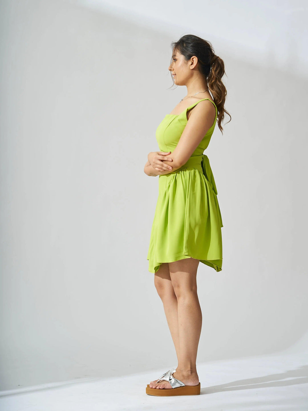Risate backless bow mini dress in bright green with a layered design, perfect for summer outings