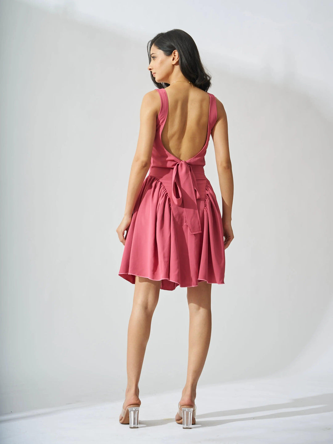 Risate backless bow mini dress in pink with a stylish open back and tied waist detail