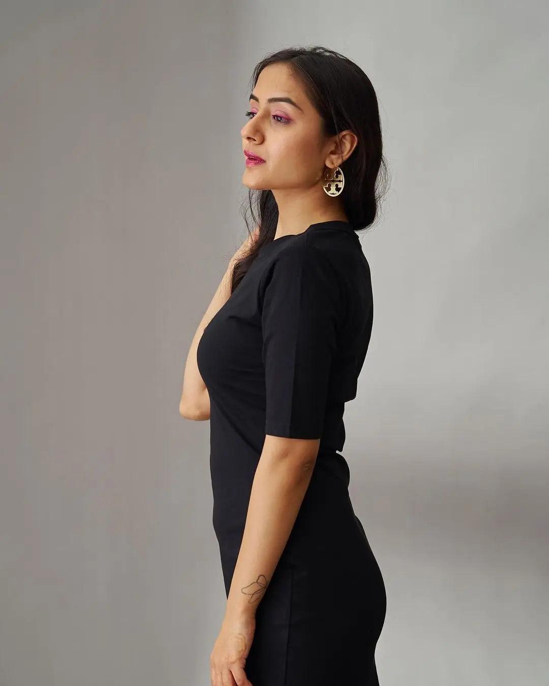 Stylish black midi bodycon dress by Risate, featuring a fitted silhouette and elegant sleeves