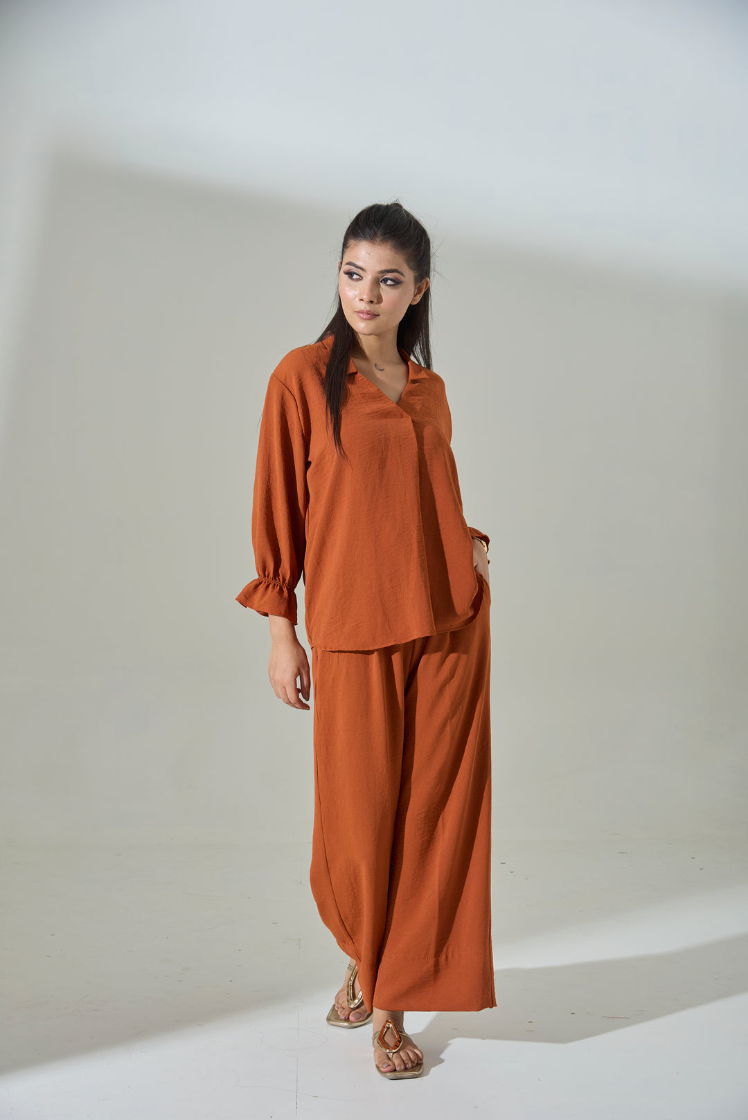 Burnt orange crepe coord set featuring a relaxed blouse and wide-leg pants for chic styling