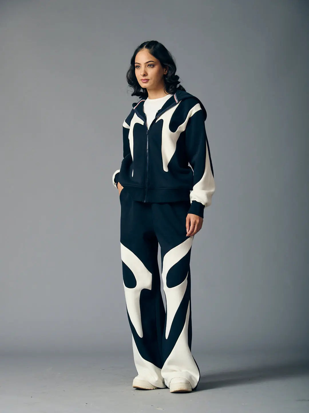 Risate chic streetwear set for women featuring a stylish black and white design with a zip-up jacket and wide-leg pants