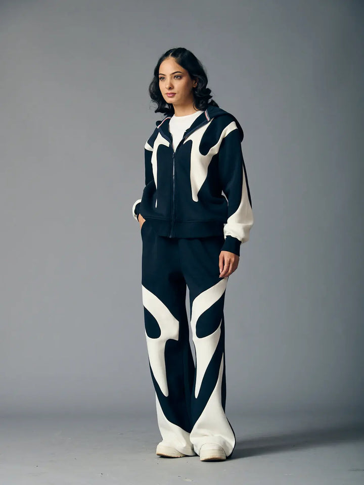 Risate chic streetwear set for women featuring a stylish black and white design with a zip-up jacket and wide-leg pants
