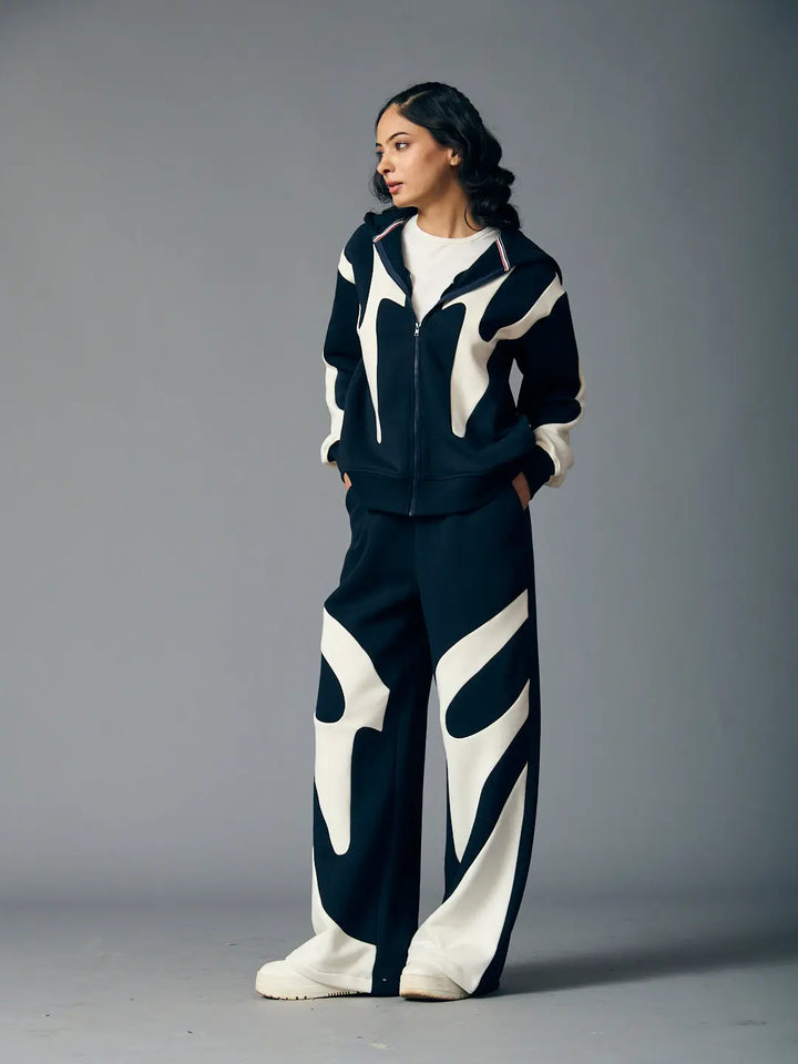 Risate chic streetwear set for women featuring a stylish black and white design with a zip-up jacket and relaxed pants