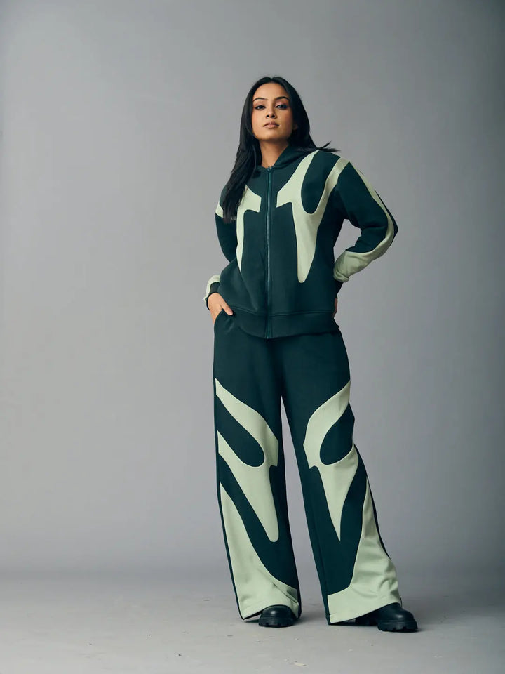 Risate chic streetwear set for women featuring a stylish hoodie and matching wide-leg pants in dark green and light accents