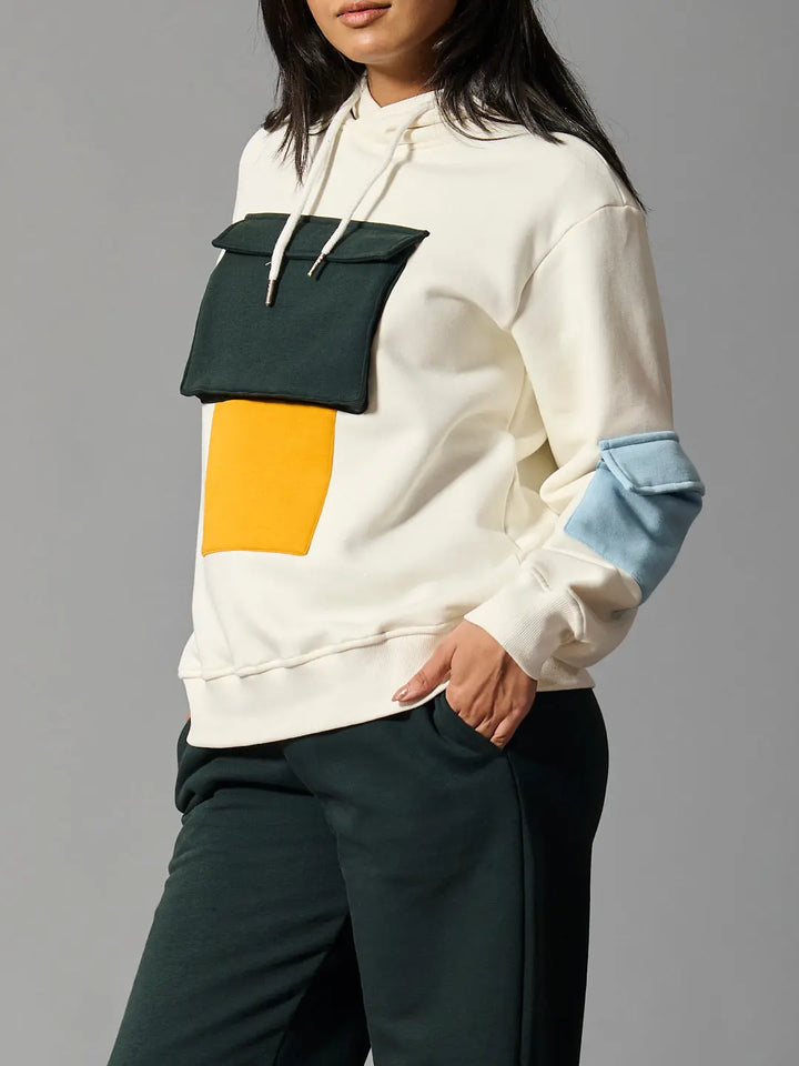 Risate color block hoodie for women featuring vibrant patches in blue, green, and yellow