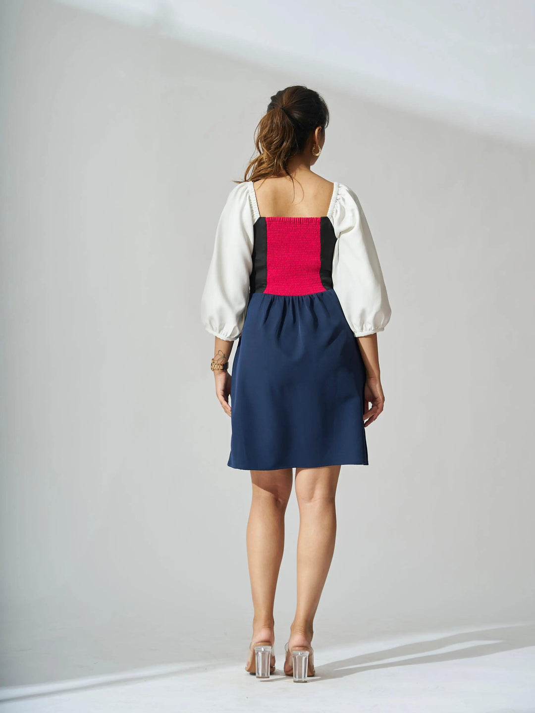 Back view of Risate colorblock mini dress for women with puff sleeves and fitted bodice