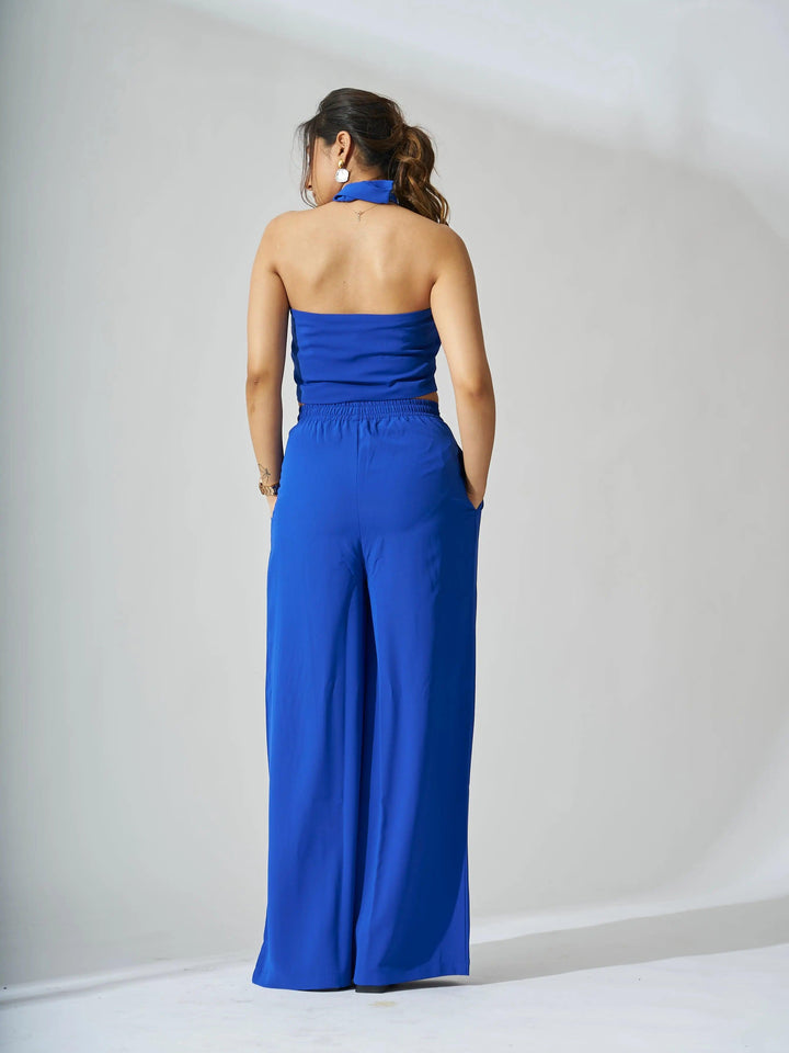 Back view of a Risate cross neck cropped waistcoat set in vibrant blue with wide-leg pants