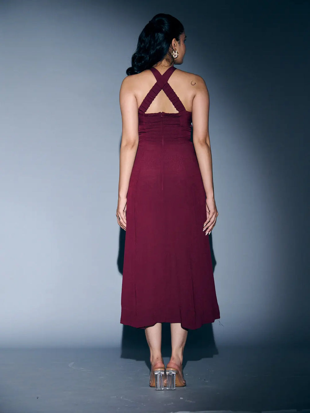 Back view of a Risate crossneck crepe maxi dress in burgundy with stylish crisscross straps