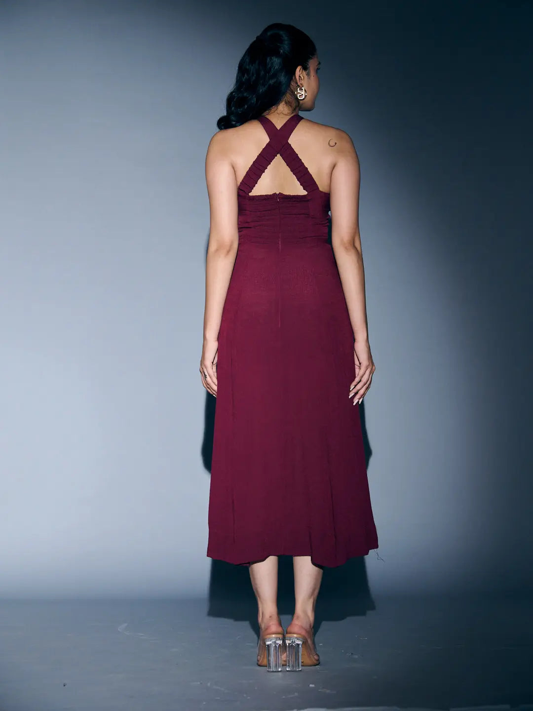 Back view of a Risate crossneck crepe maxi dress in burgundy with stylish crisscross straps