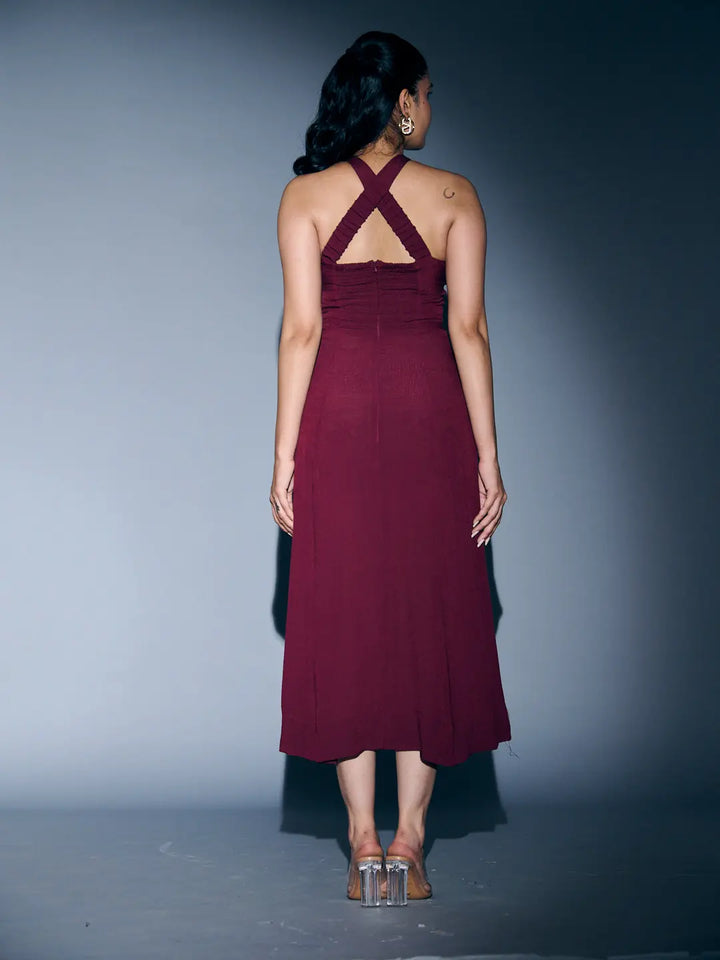 Back view of a Risate crossneck crepe maxi dress in burgundy with stylish crisscross straps