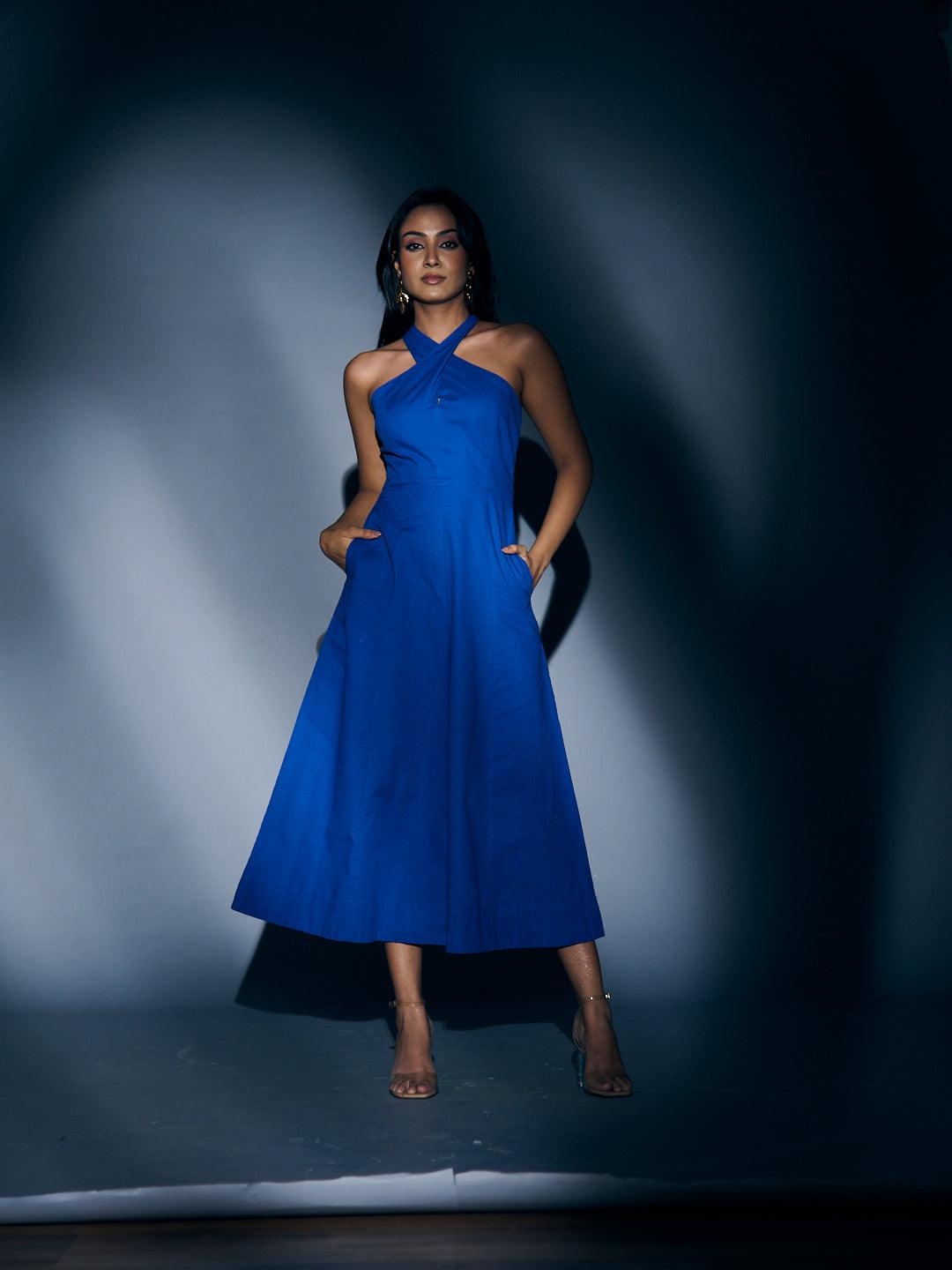 Elegant Risate crossneck linen maxi dress in vibrant blue with a flowing silhouette and pockets
