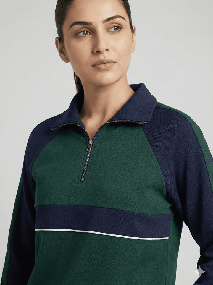 Woman modeling emerald navy luxe trackset for women with zip-up collar and stylish color blocking.