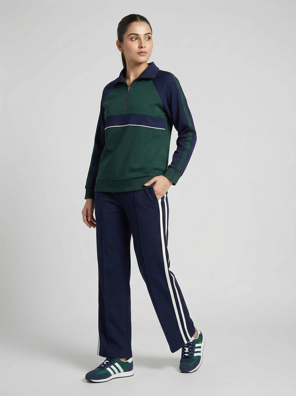 Emerald navy luxe trackset for women featuring a zip-up top and striped pants from Risate