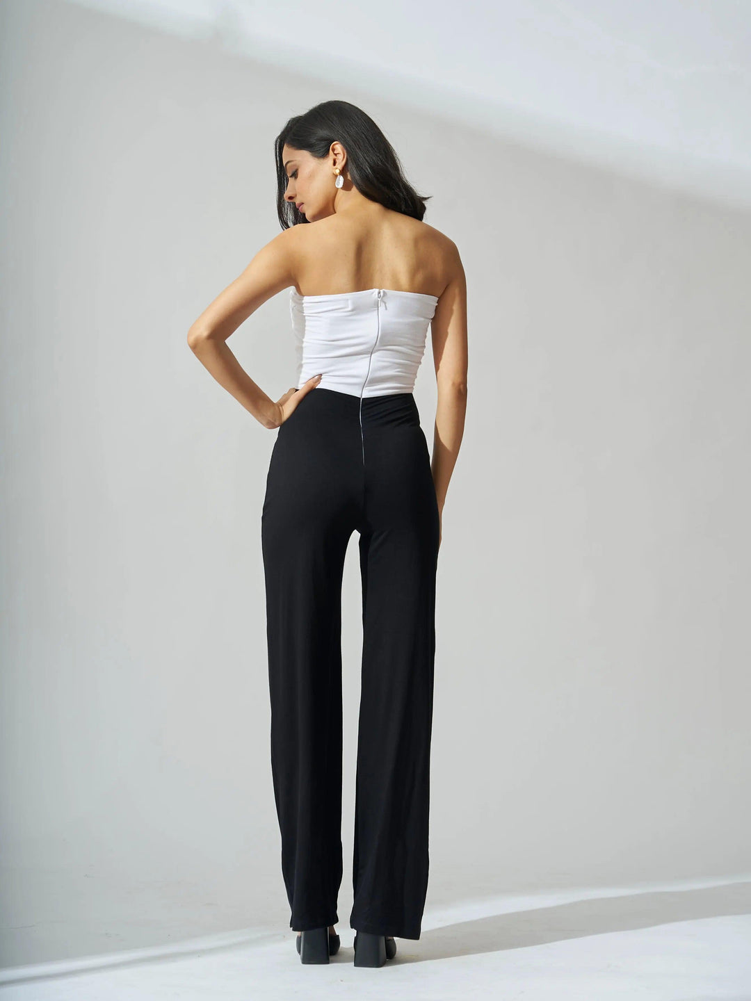 Black front knot off shoulder jumpsuit with a fitted bodice and wide-leg design by Risate