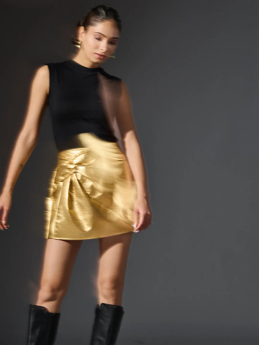 Risate gold metallic mini skirt featuring a stylish twisted design for a trendy look