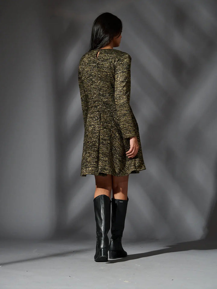 Back view of a Risate golden knit glam dress with a flared skirt and long sleeves
