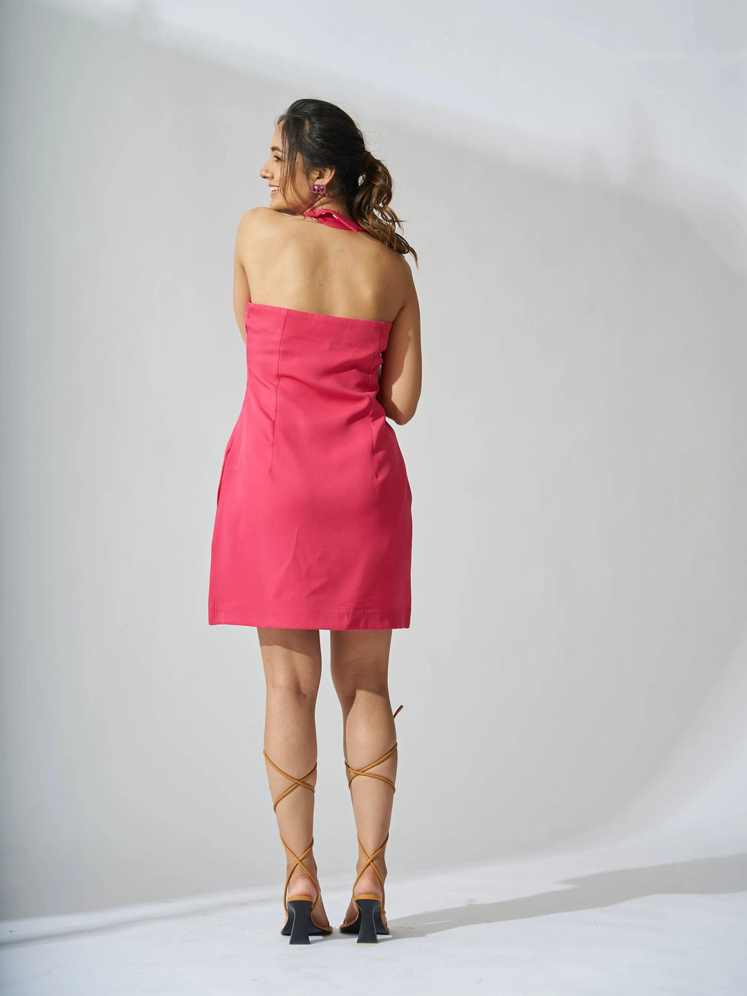Back view of a Risate halterneck crepe mini dress in pink, perfect for summer outings