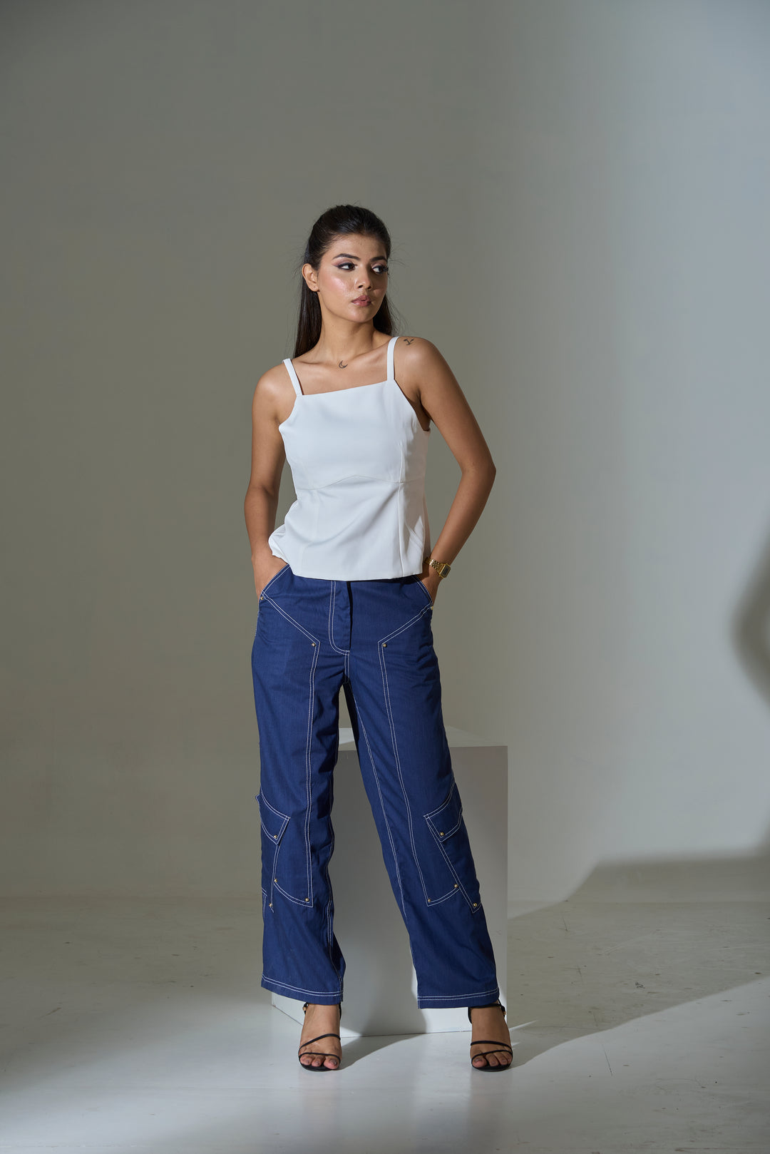 Ivory bow-back cami top paired with stylish denim pants for a trendy summer look