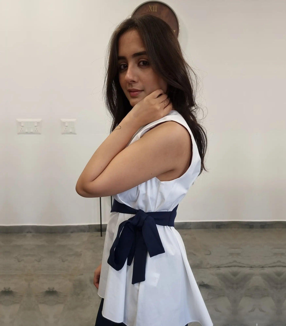 Risate matching set in white and navy featuring a stylish peplum top with a bow detail