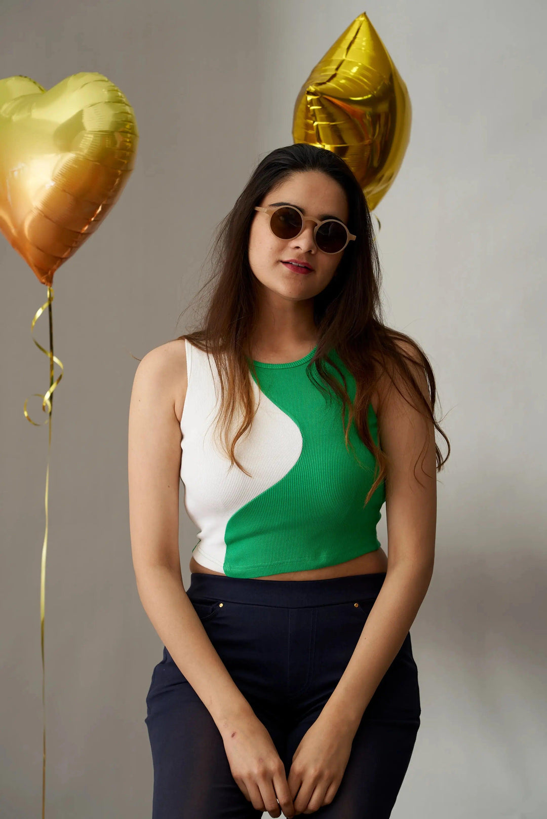 Mia crop top for women in green and white design, styled with round sunglasses and balloons