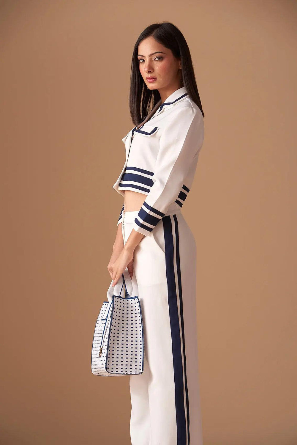 Side view of a white and navy striped Risate old navy denim blazer styled with matching pants