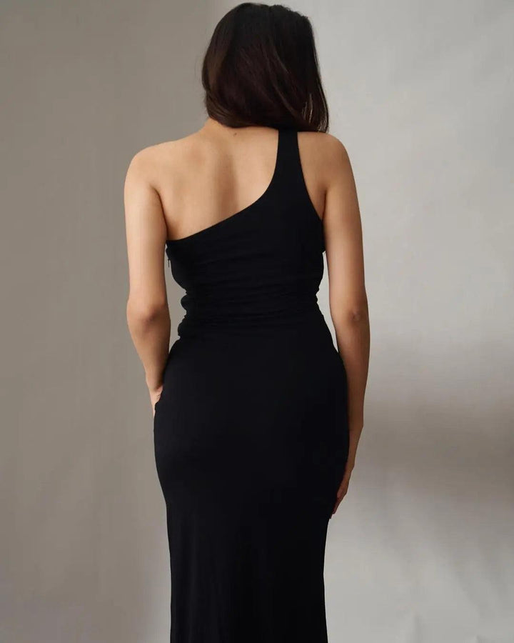 Back view of a Risate one shoulder black dress for women, featuring a fitted silhouette and elegant design.
