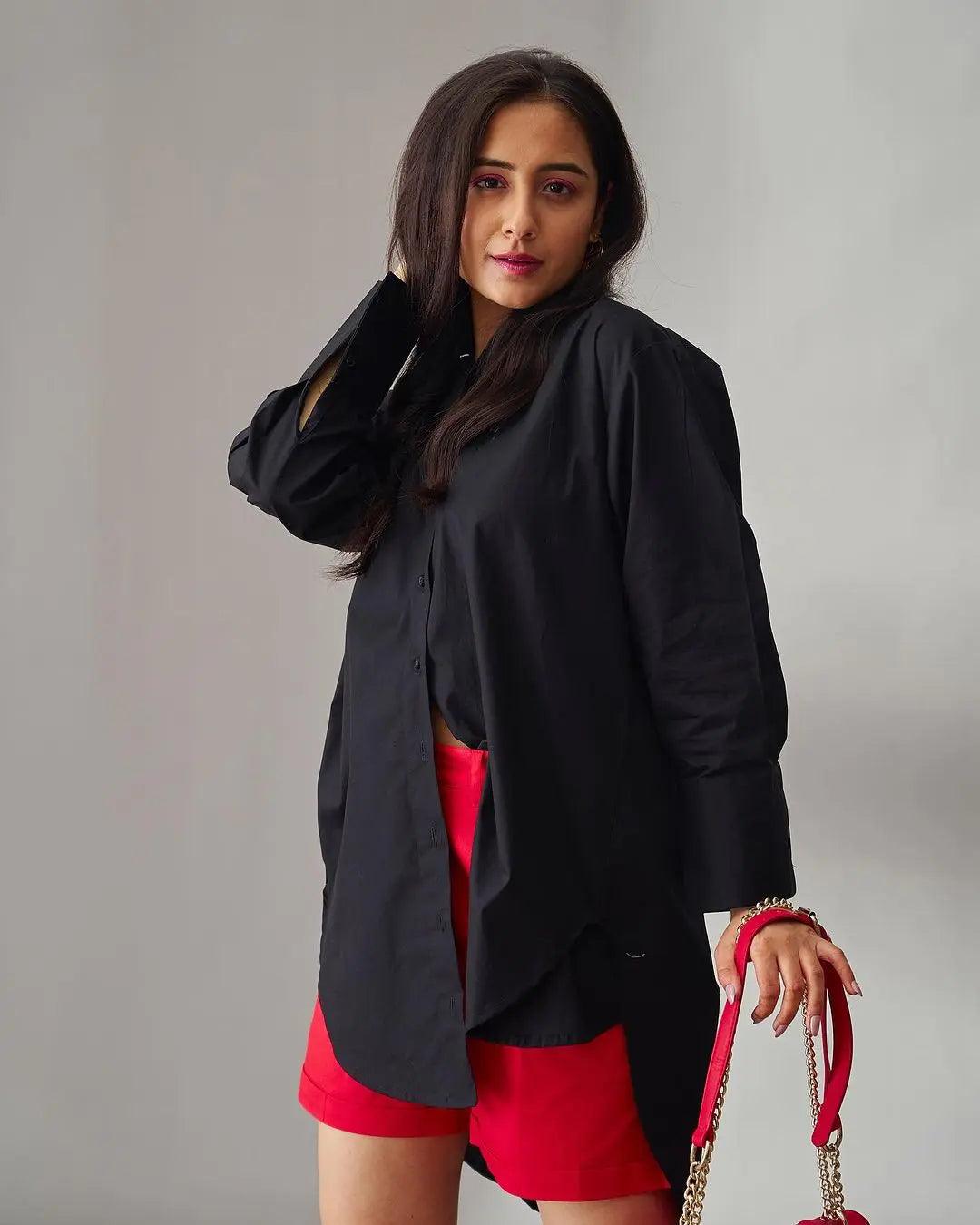 Black oversized poplin shirt for women styled with red shorts and accessories