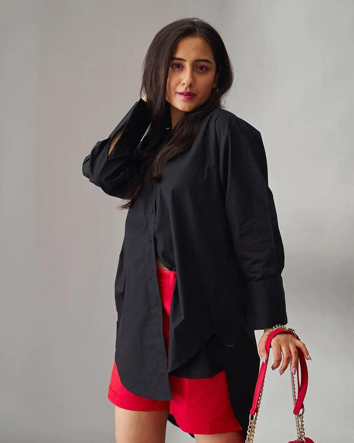 Black oversized poplin shirt for women styled with red shorts and accessories