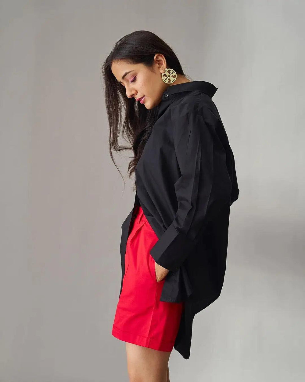 Risate oversized poplin shirt for women in black styled with bright red shorts