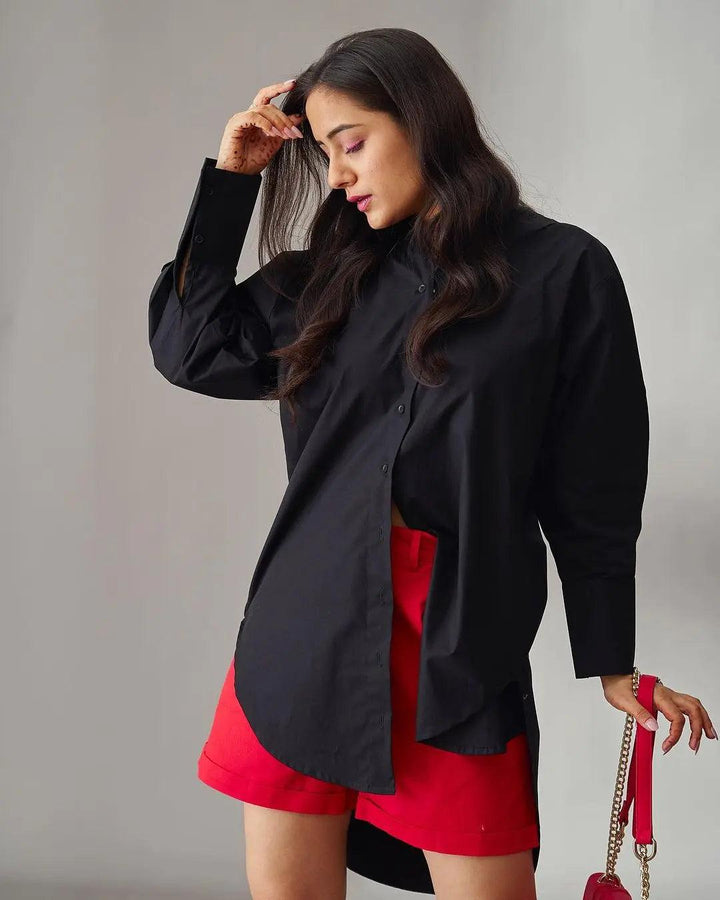 Stylish oversized poplin shirt for women in black, paired with red shorts for a chic look