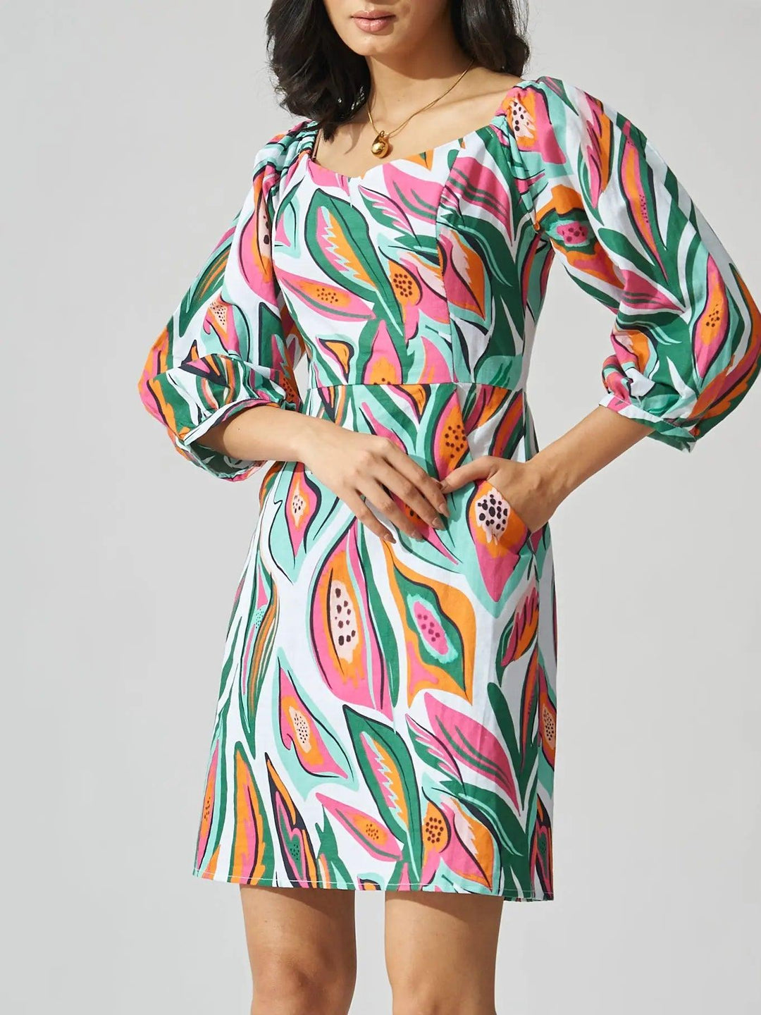 Risate papaya print linen mini dress with puff sleeves and vibrant tropical pattern