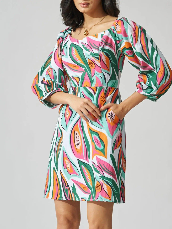 Risate papaya print linen mini dress with puff sleeves and vibrant tropical pattern