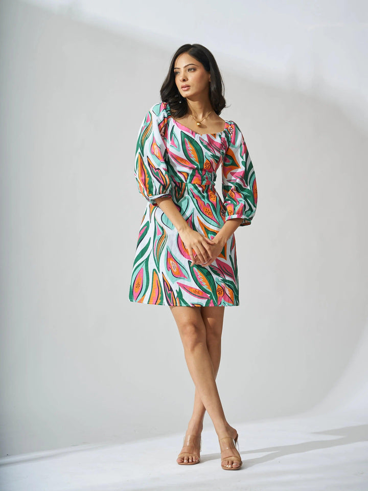 Risate papaya print linen mini dress with puff sleeves and a vibrant tropical pattern