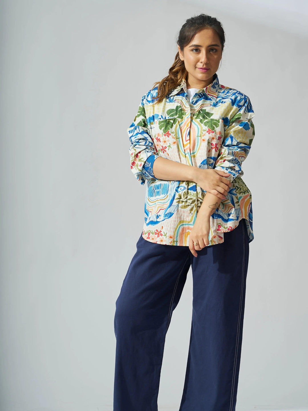 Risate personage print cotton shirt for women in colorful floral design, styled with navy pants