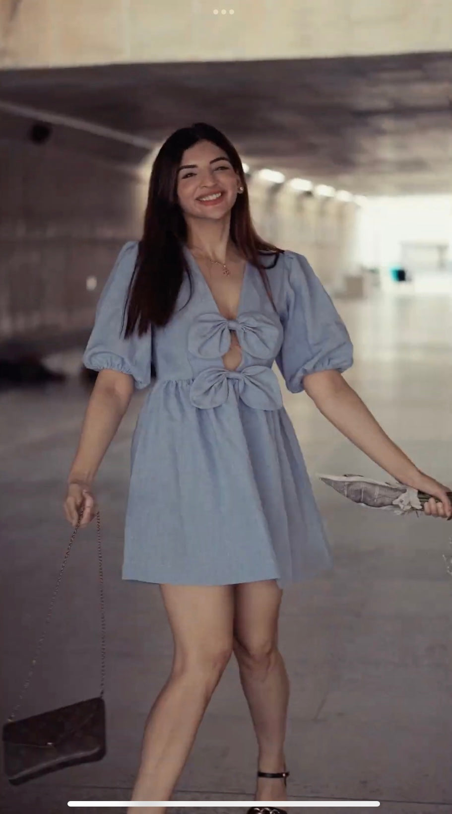 Risate puff sleeve mini dress in light blue with a playful cutout and bow detail
