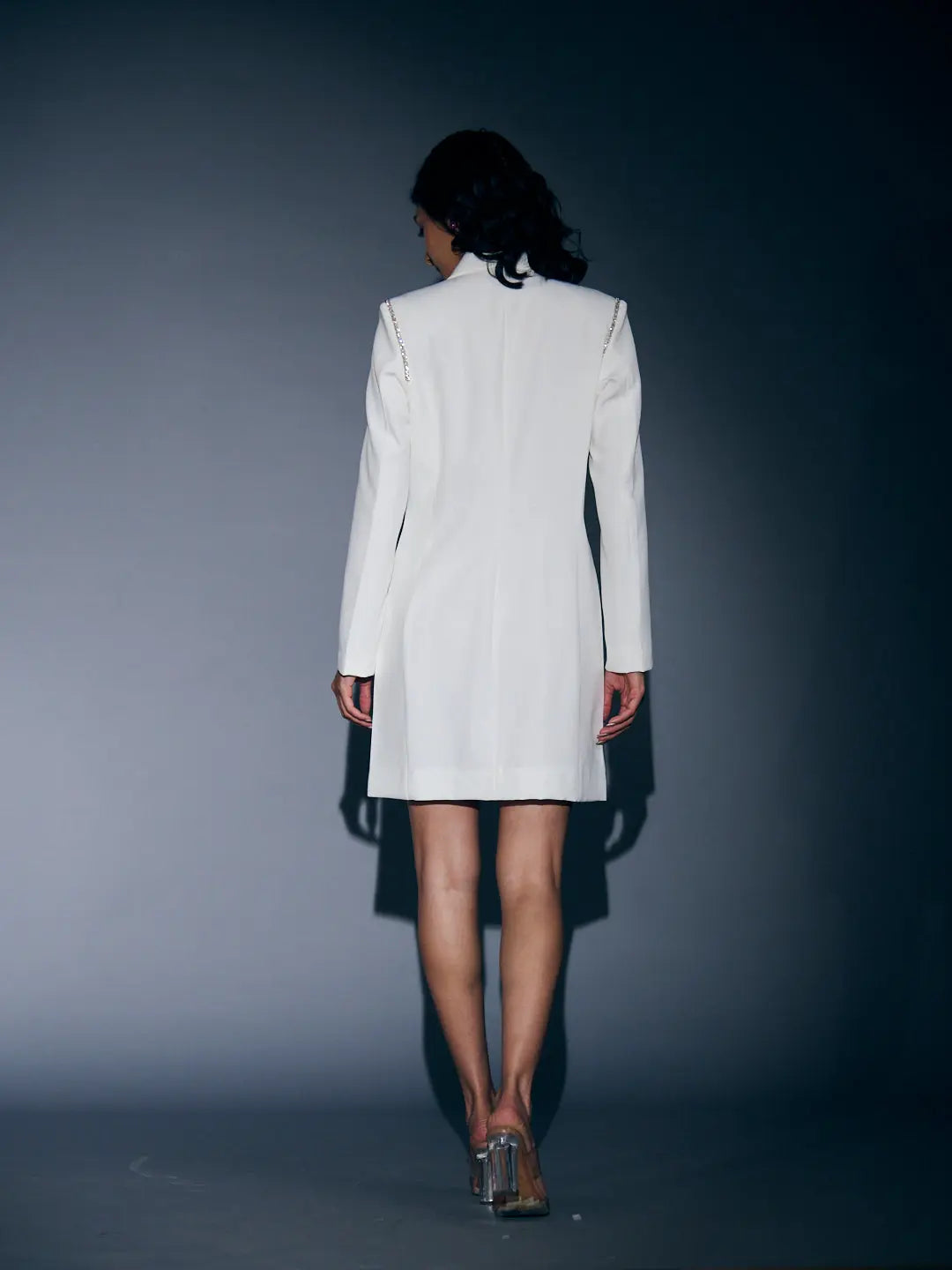 Back view of a white Risate rhinestone blazer dress for women with long sleeves and a fitted silhouette