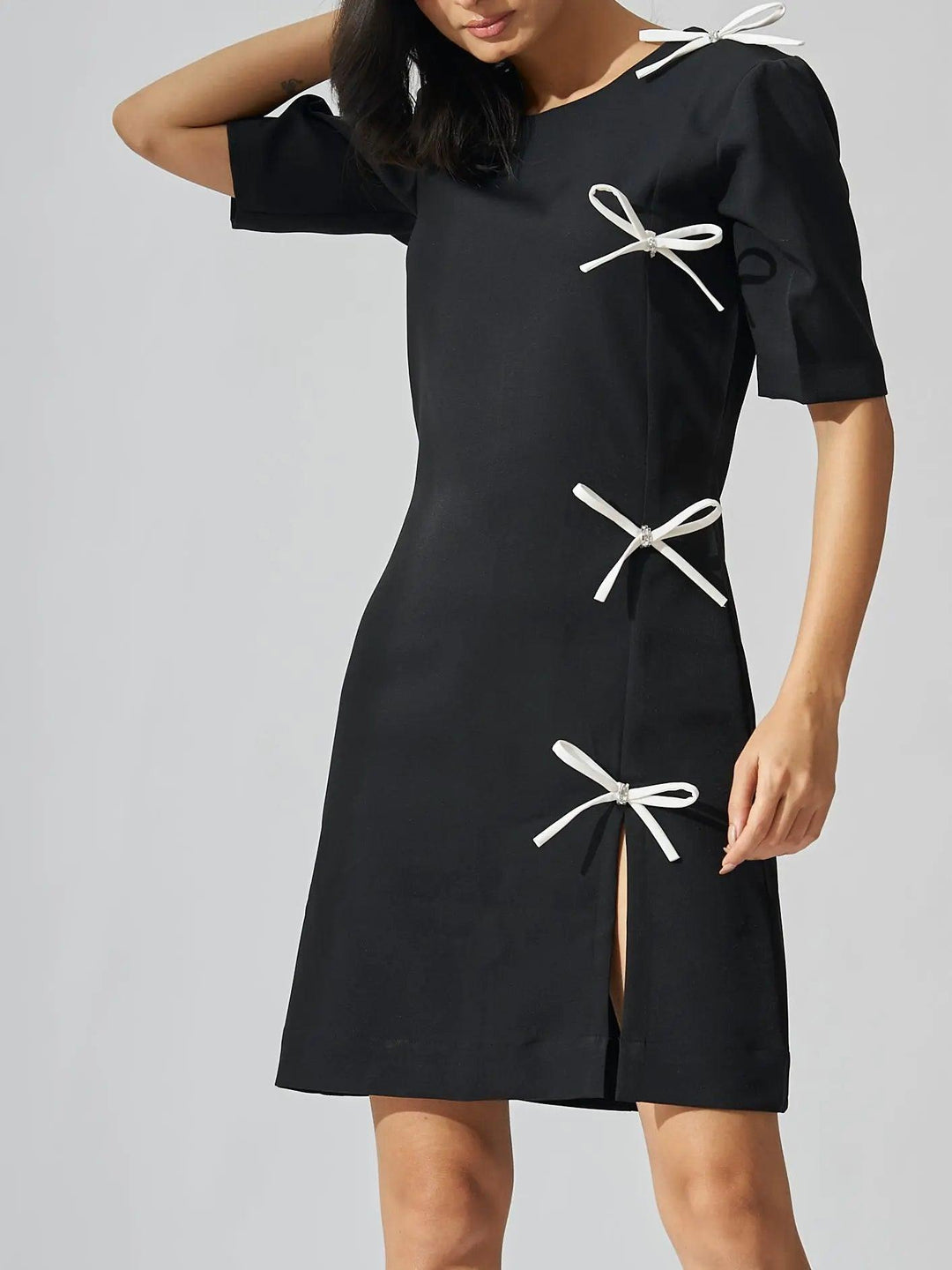 Risate rhinestone bow shift dress in black with stylish bows and a slit for a chic look