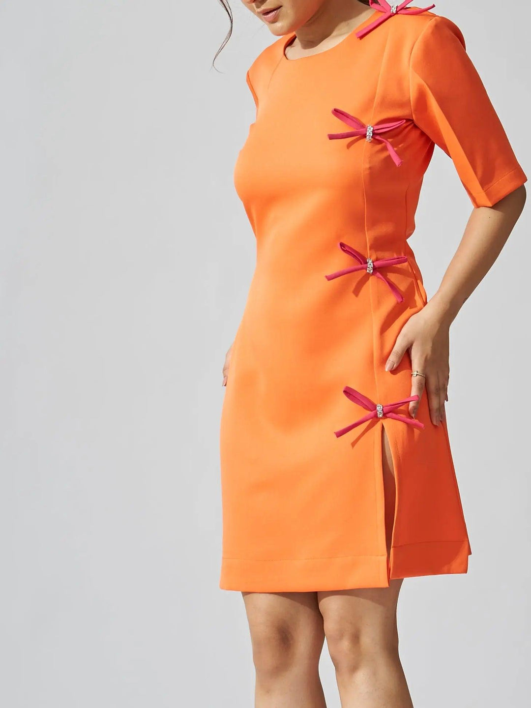 Risate rhinestone bow shift dress in vibrant orange with decorative bow accents
