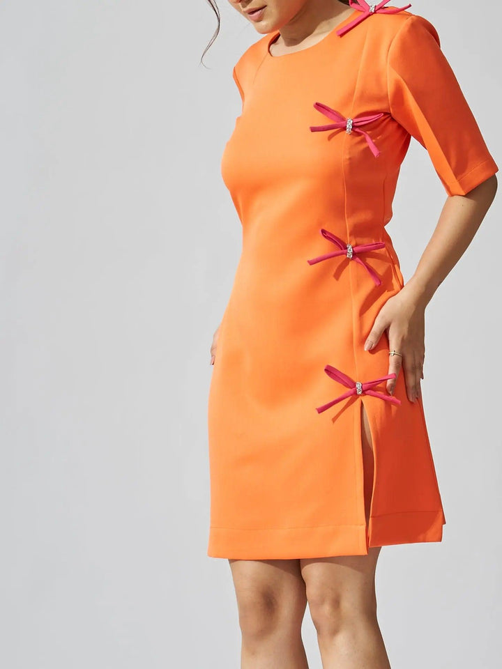 Risate rhinestone bow shift dress in vibrant orange with decorative bow accents