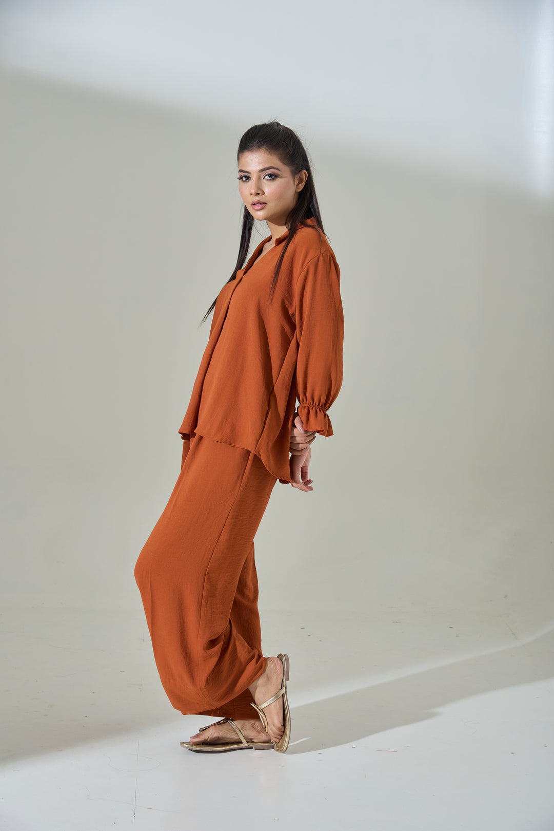Stylish burnt orange crepe coord set featuring a flowy top and matching pants for a chic look