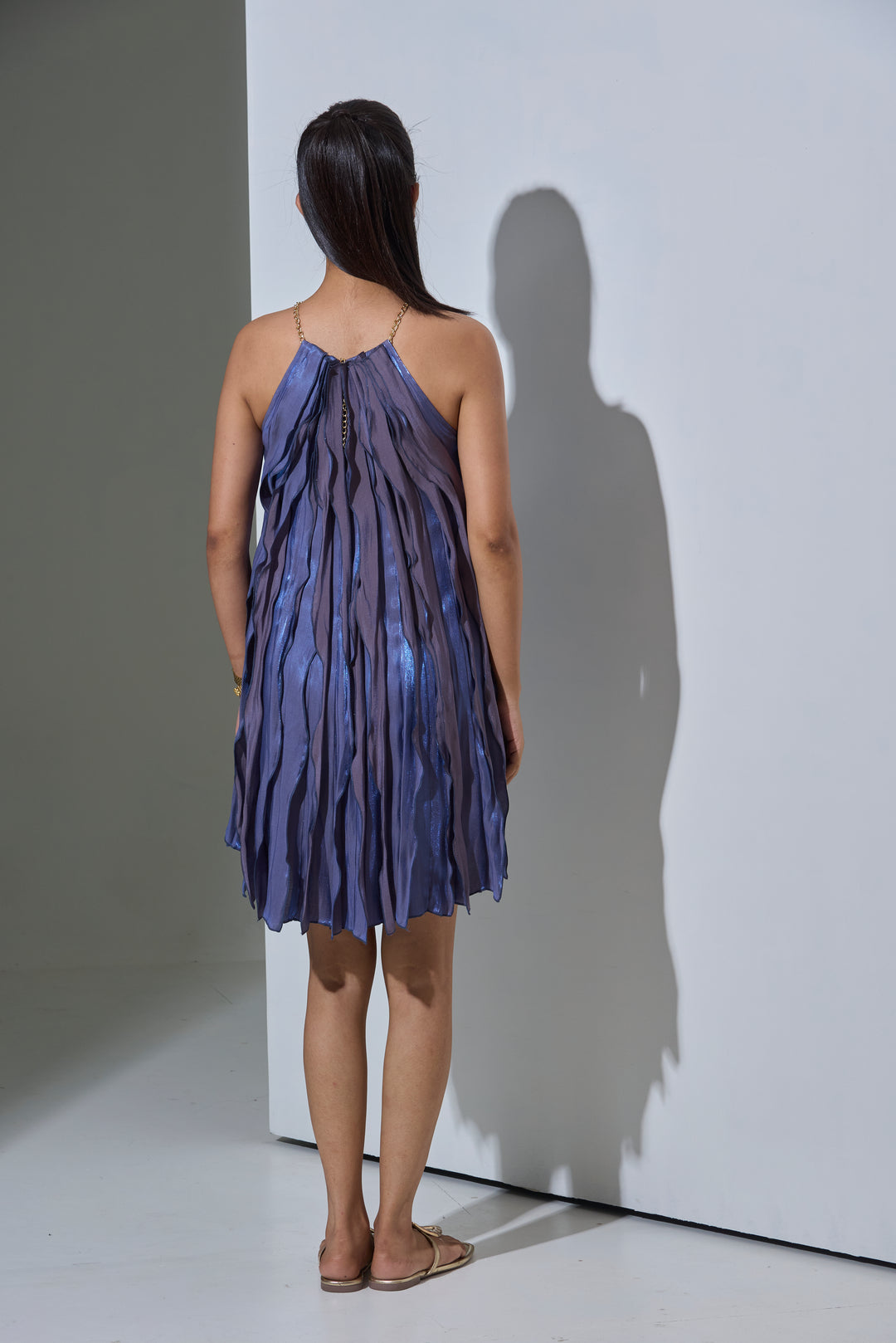 Back view of the Risate Twilight Wave Dress for women with flowing layers in shades of blue