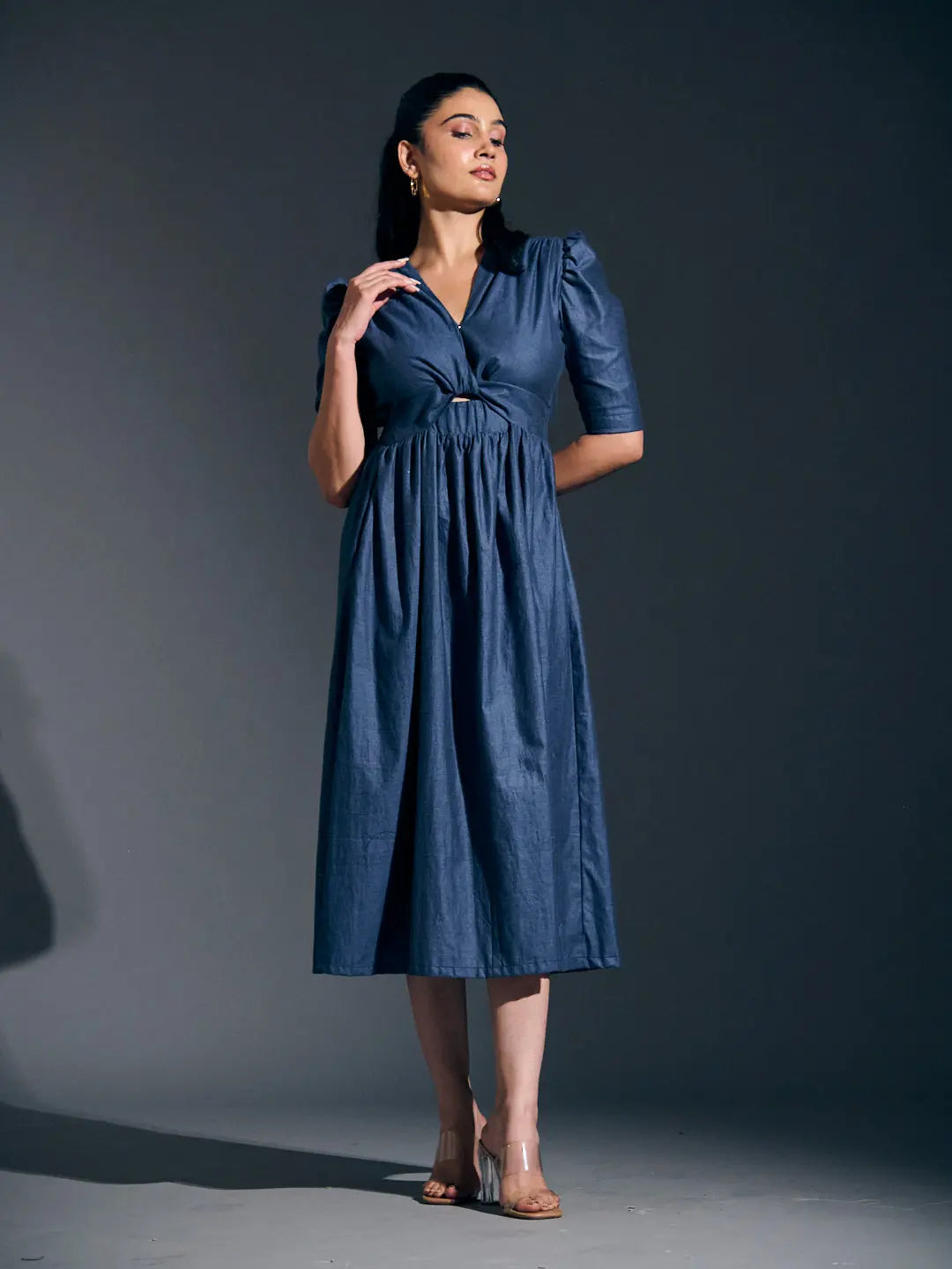 Risate twist detail maxi dress in navy blue featuring a gathered waist and stylish puff sleeves